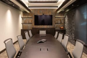 Modern conference room with long table and chairs.